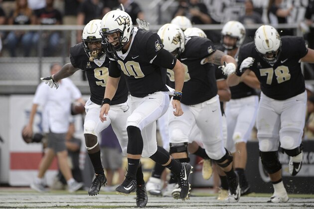 Central Florida running back Adrian Killins Jr. (9) and quarterback McKenzie Milton (10) celebrate after Killins rushed for a 24-yard touchdown during the first half of an NCAA college football game against South Carolina State Saturday, Sept. 8, 2018, in Orlando, Fla. (AP Photo/Phelan M. Ebenhack)