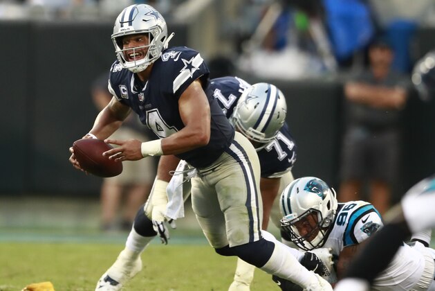Dallas Cowboys' Dak Prescott (4) is sacked by Carolina Panthers' Wes Horton (96) during the second half of an NFL football game in Charlotte, N.C., Sunday, Sept. 9, 2018. (AP Photo/Jason E. Miczek)