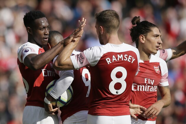 Arsenal's Danny Welbeck, celebrates with his teammates after he scored his side third goal during the English Premier League soccer match between Arsenal and West Ham United at the Emirates Stadium in London, Saturday Aug. 25, 2018. (AP Photo/Tim Ireland)