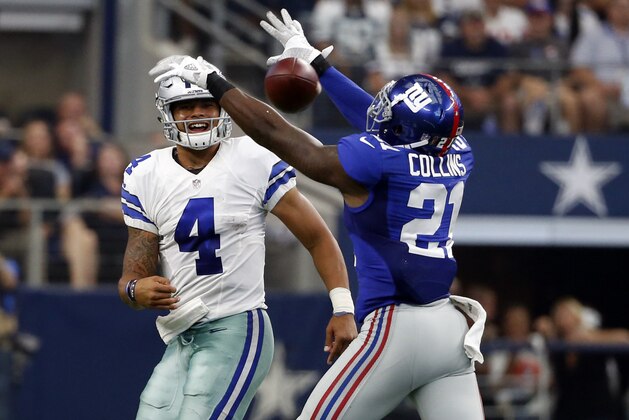 Dallas Cowboys quarterback Dak Prescott (4) throws an incomplete pass through eh arms of New York Giants free safety Landon Collins (21) in the second half of an NFL football game, Sunday Sept. 11,  2016, in Arlington, Texas. (AP Photo/Michael Ainsworth)