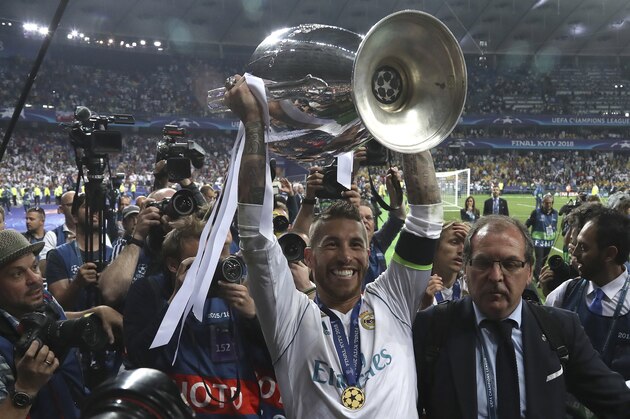 Real Madrid's Sergio Ramos celebrates with the trophy after winning the Champions League Final soccer match between Real Madrid and Liverpool at the Olimpiyskiy Stadium in Kiev, Ukraine, Saturday, May 26, 2018. (AP Photo/Sergei Grits)