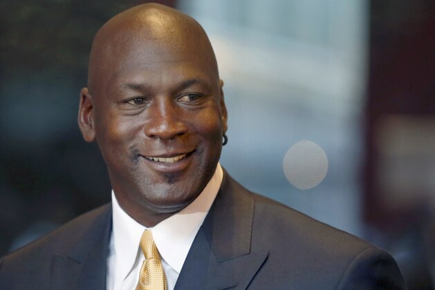 FILE - In this Aug. 21, 2015, file photo, former NBA star and current owner of the Charlotte Hornets, Michael Jordan, smiles at reporters in Chicago. Jordan announced Monday, July 25, 2016,  he’s giving $1 million to the Institute for Community-Police Relations and $1 million to the NAACP Legal Defense Fund to help build trust between blacks and law enforcement following several disturbing clashes around the country. (AP Photo/Charles Rex Arbogast, File)