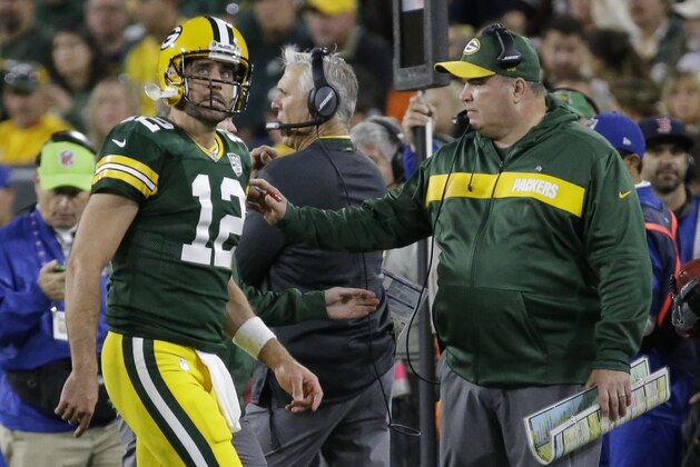 Green Bay Packers head coach Mike McCarthy looks at Aaron Rodgers as he walks off the field after injuring his leg during the first half of an NFL football game against the Chicago Bears Sunday, Sept. 9, 2018, in Green Bay, Wis. (AP Photo/Mike Roemer)