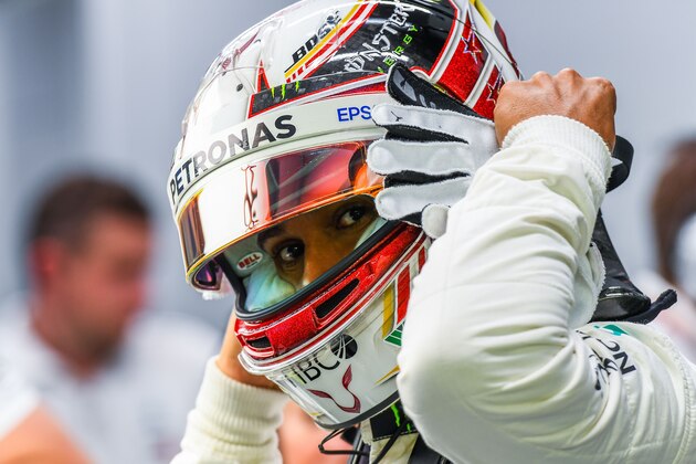 Mercedes' British driver Lewis Hamilton gets ready in the pits at the Marina Bay Street Circuit during the second practice session ahead of the Singapore Formula One Grand Prix in Singapore on September 14, 2018. (Photo by Manan VATSYAYANA / AFP)        (Photo credit should read MANAN VATSYAYANA/AFP/Getty Images)