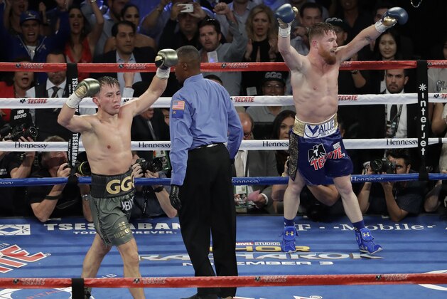Canelo Alvarez, right, and Gennady Golovkin celebrate following a middleweight title fight Sunday, Sept. 17, 2017, in Las Vegas. The fight was called a draw. (AP Photo/Isaac Brekken)