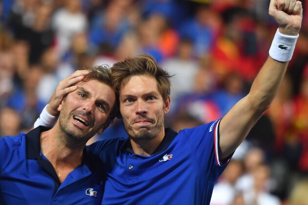 France's Nicolas Mahut (R) embraces teammate Julien Benneteau after victory in their doubles rubber against Spain's Marcel Granollers and Feliciano Lopez for the Davis Cup semi-final tennis match between France and Spain at Villeneuve-d'Ascq, northern France, on September 15, 2018. (Photo by Denis Charlet / AFP)        (Photo credit should read DENIS CHARLET/AFP/Getty Images)