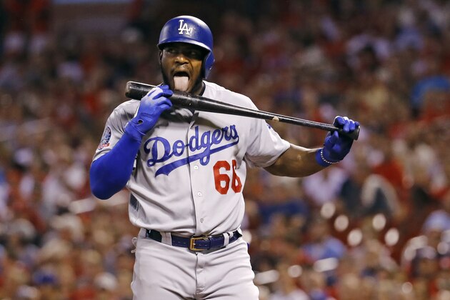Los Angeles Dodgers' Yasiel Puig licks his bat during the first inning of a baseball game against the St. Louis Cardinals Friday, Sept. 14, 2018, in St. Louis. (AP Photo/Billy Hurst)