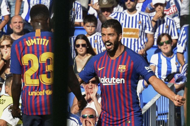 FC Barcelona's Luis Suarez, right, celebrates after scoring next to his teammate Samuel Umtiti during a Spanish La Liga soccer match between Real Sociedad and FC Barcelona at the Anoeta stadium, in San Sebastian, northern Spain, Saturday, Sept. 15, 2018. (AP Photo/Jose Ignacio Unanue)
