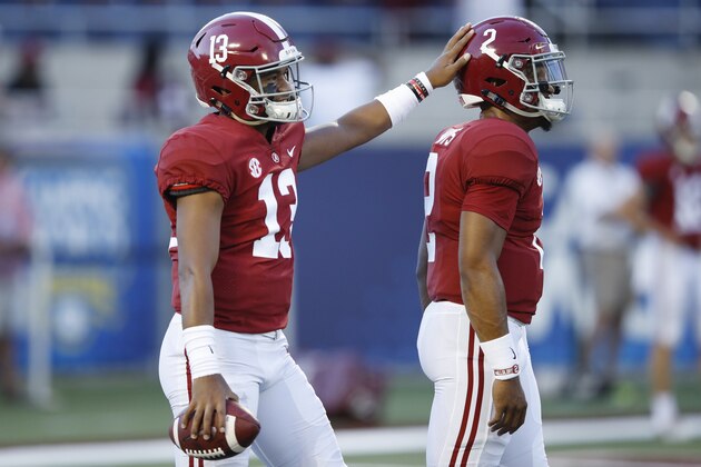 ORLANDO, FL - SEPTEMBER 01: Tua Tagovailoa #13 of the Alabama Crimson Tide pats the helmet of teammate Jalen Hurts #2 prior to a game against the Louisville Cardinals at Camping World Stadium on September 1, 2018 in Orlando, Florida. Alabama won 51-14. (Photo by Joe Robbins/Getty Images)