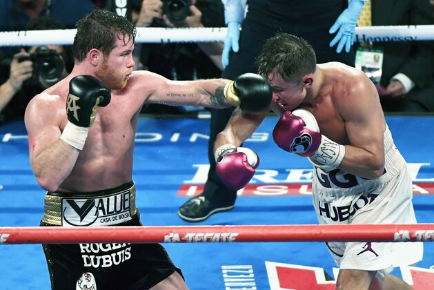 LAS VEGAS, NV - SEPTEMBER 15:  Canelo Alvarez (L) throws a left at Gennady Golovkin in the 12th round of their WBC/WBA middleweight title fight at T-Mobile Arena on September 15, 2018 in Las Vegas, Nevada. Alvarez won by majority decision.  (Photo by Ethan Miller/Getty Images)