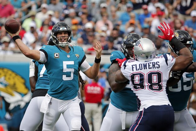 Jacksonville Jaguars quarterback Blake Bortles (5) throws a pass as he is pressured by New England Patriots defensive end Trey Flowers (98) during the first half of an NFL football game, Sunday, Sept. 16, 2018, in Jacksonville, Fla. (AP Photo/Stephen B. Morton)