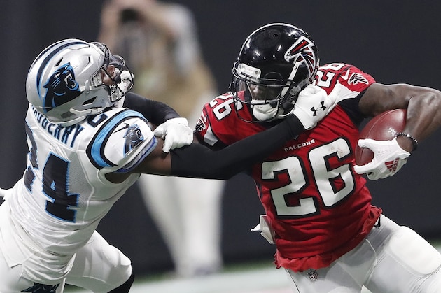 Atlanta Falcons running back Tevin Coleman (26) runs against Carolina Panthers cornerback James Bradberry (24) during the second half of an NFL football game, Sunday, Sept. 16, 2018, in Atlanta. (AP Photo/John Bazemore)