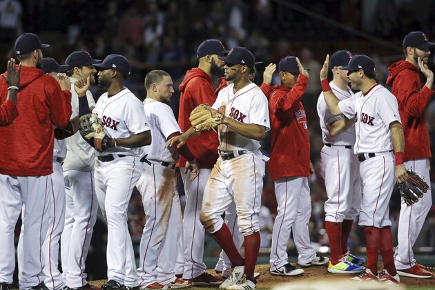 Boston Red Sox players celebrate their 4-3 victory over the Toronto Blue Jays in a baseball game at Fenway Park, Thursday, Sept. 13, 2018, in Boston. (AP Photo/Elise Amendola)