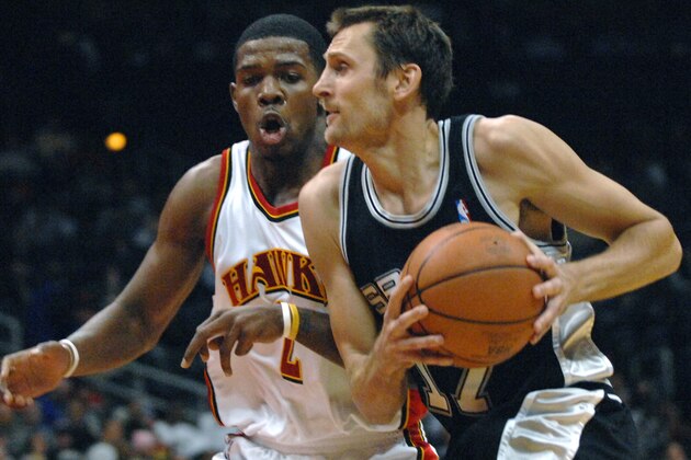 San Antonio Spurs guard Brent Barry, right, drives against Atlanta Hawks guard Joe Johnson during the first quarter of an NBA basketball game Wednesday, Feb. 21, 2007, in Atlanta. (AP Photo/Gregory Smith)