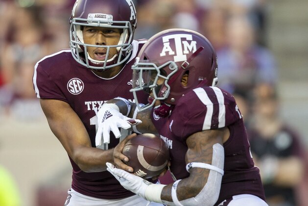 Texas A&M quarterback Kellen Mond (11) hands the ball off to running back Trayveon Williams (5) during the first half of an NCAA college football game against Louisiana Monroe Saturday, Sept. 15 2018, in College Station, Texas. (AP Photo/Sam Craft)