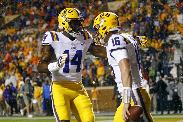 LSU quarterback Danny Etling (16) is congratulated by wide receiver Drake Davis (14) after scoring a touchdown during the first half of an NCAA college football game against Tennessee on Saturday, Nov. 18, 2017, in Knoxville, Tenn. (AP Photo/Wade Payne)