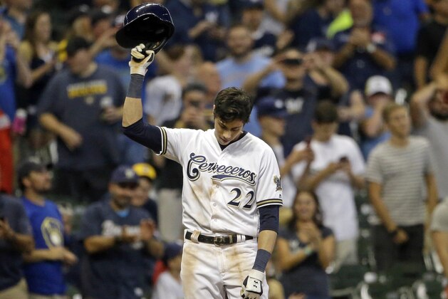 Milwaukee Brewers' Christian Yelich reacts after receiving a standing ovation from the crowd after hitting a triple to complete the cycle during the sixth inning of a baseball game against the Cincinnati Reds, Monday, Sept. 17, 2018, in Milwaukee. (AP Photo/Aaron Gash)