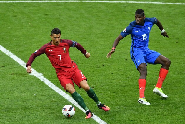 PARIS, FRANCE - JULY 10: Cristiano Ronaldo of Portugal controls the ball under pressure from Paul Pogba of France during the UEFA EURO 2016 Final match between Portugal and France at Stade de France on July 10, 2016 in Paris, France.  (Photo by Dan Mullan/Getty Images)