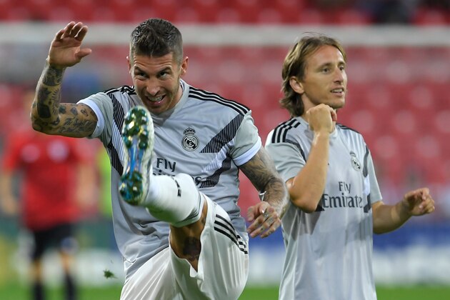 Real Madrid's Croatian midfielder Luka Modric (R) and Real Madrid's Spanish defender Sergio Ramos warm up before the Spanish league football match between Athletic Club Bilbao and Real Madrid CF at the San Mames stadium in Bilbao on September 15, 2018. (Photo by LLUIS GENE / AFP)        (Photo credit should read LLUIS GENE/AFP/Getty Images)