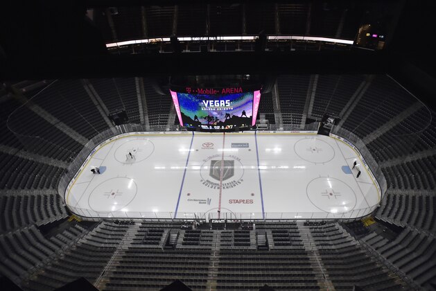 Workmen prepare the T-Mobile Arena ice before the start of an NHL hockey game between the Vegas Golden Knights and the Edmonton Oilers Thursday, Feb. 15, 2018, in Las Vegas. (AP Photo/David Becker)