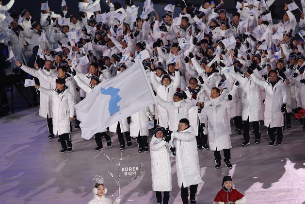 North Korea's Hwang Chung Gum and South Korea's Won Yun-jong arrive during the opening ceremony of the 2018 Winter Olympics in Pyeongchang, South Korea, Friday, Feb. 9, 2018. (AP Photo/Christophe Ena)