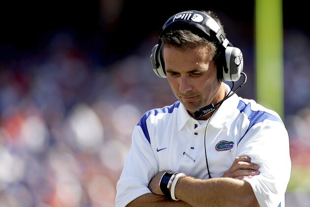 Florida head coach Urban Meyer contemplates his next move as he awaits the outcome of a play review in the final minutes of an NCAA football game against Mississippi in Gainsville, Fla., Saturday, Sept. 27, 2008. Ole Miss upset the Gators 31-30.(AP Photo/Reinhold Matay)