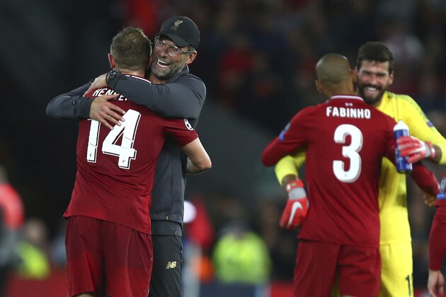 Liverpool's coach Juergen Klopp hugs Liverpool's Jordan Henderson after the Champions League Group C soccer match between Liverpool and Paris-Saint-Germain at Anfield stadium in Liverpool, England, Tuesday, Sept. 18, 2018. Liverpool won the match 3-2. (AP Photo/Dave Thompson)
