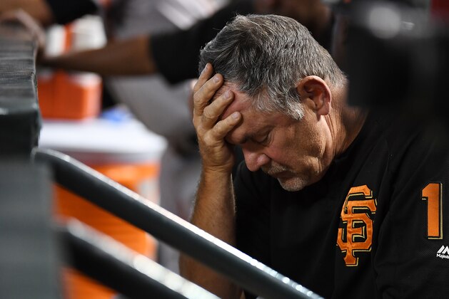 PHOENIX, AZ - AUGUST 05:  Manager Bruce Bochy #15 of the San Francisco Giants rests his head in his hand while sitting in the dugout during the third inning of a game against the Arizona Diamondbacks at Chase Field on August 5, 2018 in Phoenix, Arizona.  (Photo by Norm Hall/Getty Images)