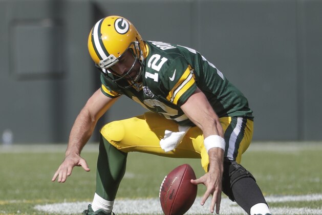 Green Bay Packers' Aaron Rodgers recovers a fumble during overtime an NFL football game against the Minnesota Vikings Sunday, Sept. 16, 2018, in Green Bay, Wis. The game ended in a 29-29 tie. (AP Photo/Morry Gash)