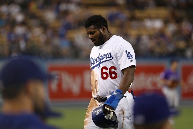 LOS ANGELES, CA - SEPTEMBER 17:  Yasiel Puig #66 of the Los Angeles Dodgers walks to the dugout after being thrown out at third base to end the first inning of the MLB game against the Colorado Rockies at Dodger Stadium on September 17, 2018 in Los Angeles, California. The Dodgers defeated the Rockies 8-2.  (Photo by Victor Decolongon/Getty Images)