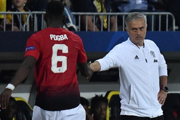 Manchester United's French midfielder Paul Pogba (L) shakes hands with Manchester United's Portuguese manager Jose Mourinho after his substitution during the UEFA Champions League group H football match between Young Boys and Manchester United at The Stade de Suisse in Bern on September 19, 2018. (Photo by Alain GROSCLAUDE / AFP)        (Photo credit should read ALAIN GROSCLAUDE/AFP/Getty Images)