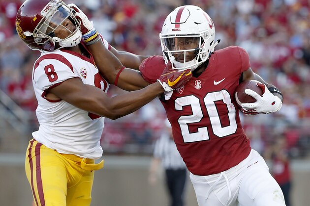 FILE - In this Saturday, Sept. 8, 2018 file photo, Stanford running back Bryce Love (20) stiff-arms Southern California cornerback Iman Marshall (8) during the first half of an NCAA college football game in Stanford, Calif. Stanford will get star running back Bryce Love back for this week's Pac-12 North showdown against No. 20 Oregon but the seventh-ranked Cardinal will be without a key defensive player. (AP Photo/Tony Avelar, File)