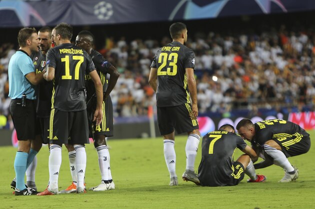 Juventus forward Cristiano Ronaldo, 2nd right, is consoled by teammate Federico Bernardeschi after receiving a red card during the Champions League, group H soccer match between Valencia and Juventus, at the Mestalla stadium in Valencia, Spain, Wednesday, Sept. 19, 2018. (AP Photo/Alberto Saiz)