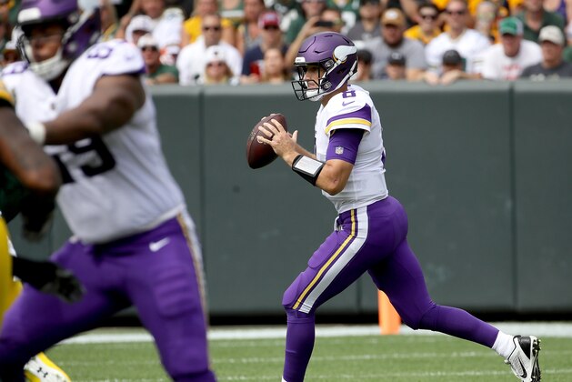 GREEN BAY, WI - SEPTEMBER 16:  Kirk Cousins #8 of the Minnesota Vikings rolls out to pass during the first quarter of a game against the Green Bay Packers at Lambeau Field on September 16, 2018 in Green Bay, Wisconsin.  (Photo by Jonathan Daniel/Getty Images)
