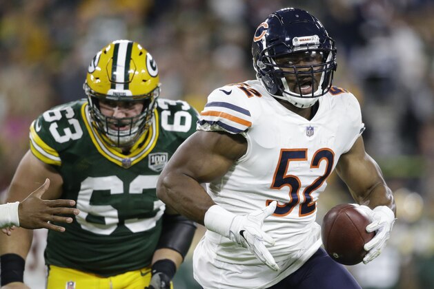 FILE - In this Sunday, Sept. 9, 2018, file photo, Chicago Bears' Khalil Mack intercepts a pass and returns it for a touchdown during the first half of an NFL football game against the Green Bay Packers in Green Bay, Wis. Mack sat out offseason workouts and the preseason, had just one week to learn a new system following a blockbuster trade and still managed to dominate in his debut for the Chicago Bears. The Bears hope for more of that when they host Russell Wilson and the Seattle Seahawks on Monday night, Sept. 17. (AP Photo/Jeffrey Phelps, File)