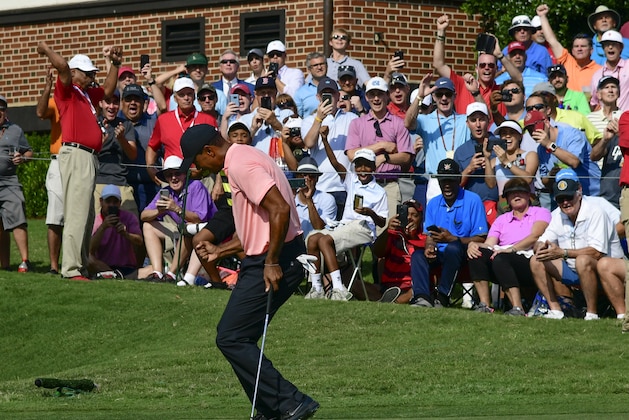 RETRANSMISSION TO CORRECT FROM A BIRDIE TO AN EAGLE - Tiger Woods reacts as he makes a eagle putt on the 18th green during the first round of the Tour Championship golf tournament Thursday, Sept. 20, 2018, in Atlanta. (AP Photo/John Amis)