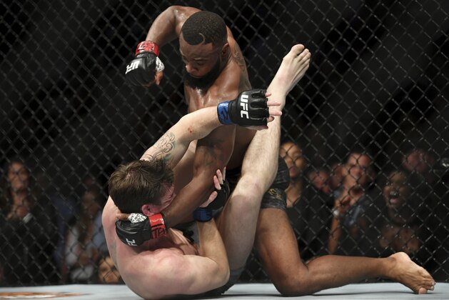Tyron Woodley, top, pummels a fallen Darren Till during their welterweight title mixed martial arts bout at UFC 228 on Saturday, Sept. 8, 2018, in Dallas. (AP Photo/Jeffrey McWhorter)