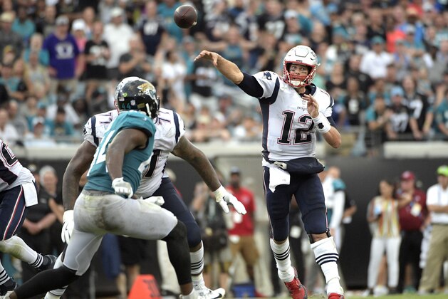 New England Patriots quarterback Tom Brady (12) throws a 29-yard pass to wide receiver Chris Hogan over Jacksonville Jaguars linebacker Myles Jack, left, during the second half of an NFL football game, Sunday, Sept. 16, 2018, in Jacksonville, Fla. (AP Photo/Phelan M. Ebenhack)