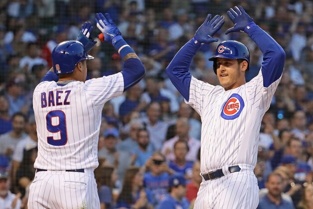 CHICAGO, IL - AUGUST 23:  Anthony Rizzo #44 of the Chicago Cubs (R) celebrates his two run home run with Javier Baez #9 in the 1st inning against the Cincinnati Reds at Wrigley Field on August 23, 2018 in Chicago, Illinois.  (Photo by Jonathan Daniel/Getty Images)