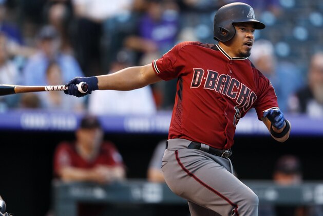 Arizona Diamondbacks' Eduardo Escobar lines out against Colorado Rockies starting pitcher Jon Gray in the first inning of a baseball game Wednesday, Sept. 12, 2018, in Denver. (AP Photo/David Zalubowski)