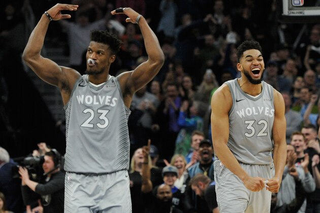 MINNEAPOLIS, MN - APRIL 11: Jimmy Butler #23 and Karl-Anthony Towns #32 of the Minnesota Timberwolves celebrate in the final minute of overtime of the game against the Denver Nuggets on April 11, 2018 at the Target Center in Minneapolis, Minnesota. The Timberwolves defeated the Nuggets 112-106. NOTE TO USER: User expressly acknowledges and agrees that, by downloading and or using this Photograph, user is consenting to the terms and conditions of the Getty Images License Agreement. (Photo by Hannah Foslien/Getty Images)