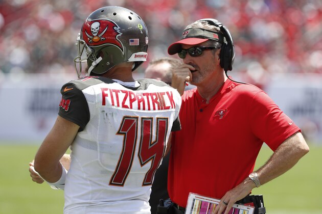 Tampa Bay Buccaneers head coach Dirk Koetter talks to quarterback Ryan Fitzpatrick (14), during the first half of an NFL football game against the Philadelphia Eagles, Sunday, Sept. 16, 2018, in Tampa, Fla. (AP Photo/Mark LoMoglio)