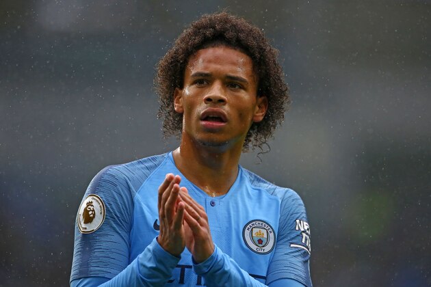 Manchester City's German midfielder Leroy Sane applauds supporters on the pitch after the English Premier League football match between between Cardiff City and Manchester City at Cardiff City Stadium in Cardiff, south Wales on September 22, 2018. - Manchester City won the game 5-0. (Photo by Geoff CADDICK / AFP) / RESTRICTED TO EDITORIAL USE. No use with unauthorized audio, video, data, fixture lists, club/league logos or 'live' services. Online in-match use limited to 120 images. An additional 40 images may be used in extra time. No video emulation. Social media in-match use limited to 120 images. An additional 40 images may be used in extra time. No use in betting publications, games or single club/league/player publications. /         (Photo credit should read GEOFF CADDICK/AFP/Getty Images)