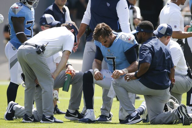 Coaches and trainers surround Tennessee Titans quarterback Blaine Gabbert (7) after he was injured during the first half of an NFL football game against the Jacksonville Jaguars, Sunday, Sept. 23, 2018, in Jacksonville, Fla. (AP Photo/Stephen B. Morton)