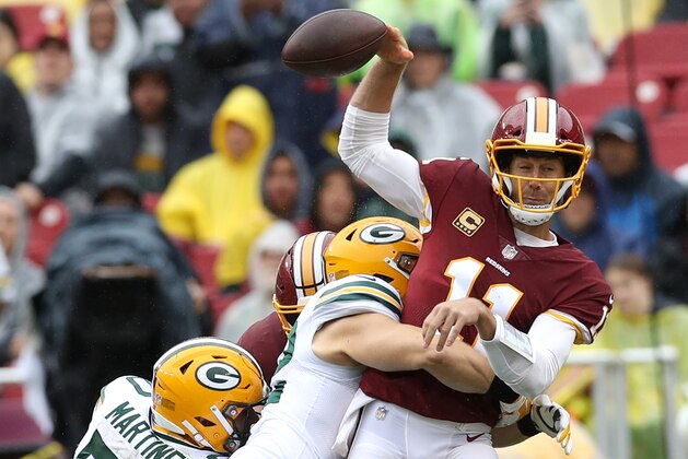 LANDOVER, MD - SEPTEMBER 23:  Clay Matthews #52 of the Green Bay Packers hits quarterback Alex Smith #11 of the Washington Redskins in the first half at FedExField on September 23, 2018 in Landover, Maryland. (Photo by Rob Carr/Getty Images)