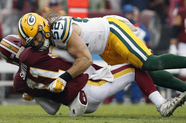 Green Bay Packers linebacker Clay Matthews (52) hits Washington Redskins quarterback Alex Smith (11) during the second half of an NFL football game, Sunday, Sept. 23, 2018 in Landover, Md. (AP Photo/Alex Brandon)