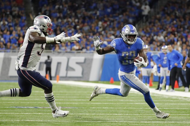 Detroit Lions running back Kerryon Johnson breaks through the New England Patriots line during the first half of an NFL football game, Sunday, Sept. 23, 2018, in Detroit. (AP Photo/Rick Osentoski)