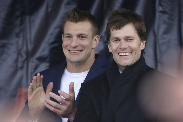 New England Patriots tight end Rob Gronkowski, left, and quarterback Tom Brady, right, stand on the stage during an NFL football Super Bowl send-off rally, Monday, Jan. 29, 2018, in Foxborough, Mass. The Patriots are to play the Philadelphia Eagles in Super Bowl 52, Sunday, Feb. 4, in Minneapolis. (AP Photo/Steven Senne)