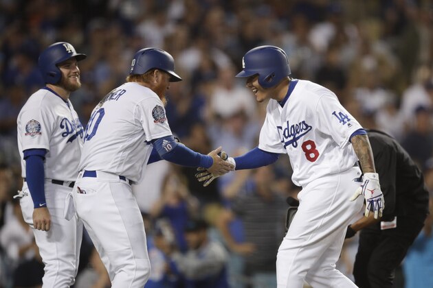Los Angeles Dodgers' Manny Machado, right, celebrates his three-run home run with Justin Turner and Max Muncy, left, during the third inning of a baseball game against the San Diego Padres, Saturday, Sept. 22, 2018, in Los Angeles. (AP Photo/Jae C. Hong)