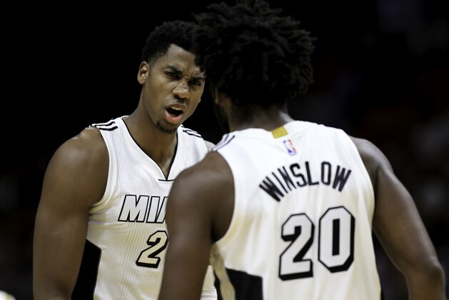 MIAMI, FL - DECEMBER 18: Hassan Whiteside #21 of the Miami Heat speaks with Justise Winslow #20 during the game against the Boston Celtics at the American Airlines Arena on December 18, 2016 in Miami, Florida. NOTE TO USER: User expressly acknowledges and agrees that, by downloading and or using this photograph, User is consenting to the terms and conditions of the Getty Images License Agreement.Ê(Photo by Rob Foldy/Getty Images)